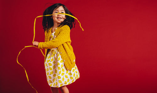 Girl waving decorative ribbons