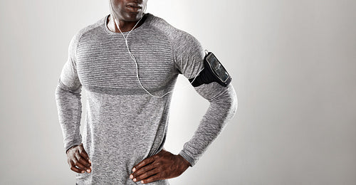 Young african man in long sleeve shirt listening music