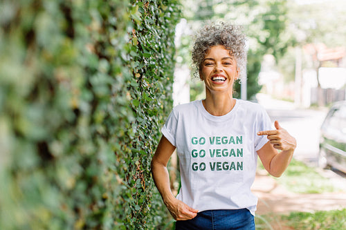 Happy mature woman advocating for veganism outdoors