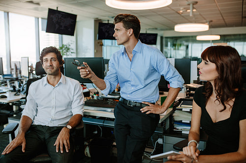 Mature businessman discussing new plans with colleagues