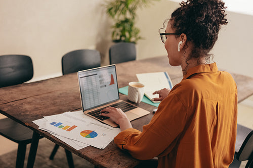 Businesswoman working on laptop at home office