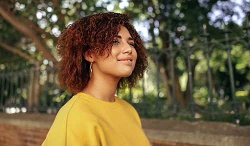 Happy teenage girl looking away with a smile outdoors