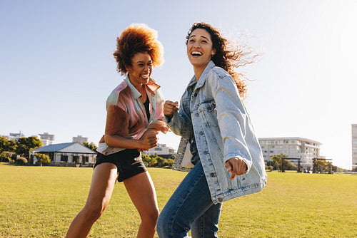 Energetic girlfriends having fun in the park