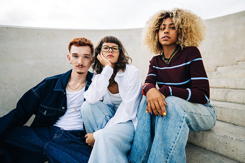 Diverse friends portrait sitting together on steps