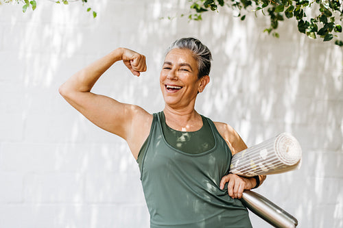 Fit and proud: Senior woman flaunts her bicep as she celebrates her fitness achievements