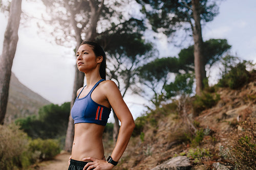 Female runner in sportswear on cross country path