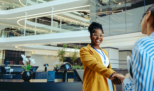 Professional handshake in a high-rise office building, symbolizing corporate success