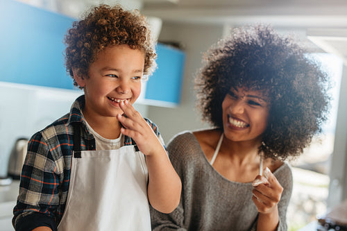 Cheerful mother and son in kitchen