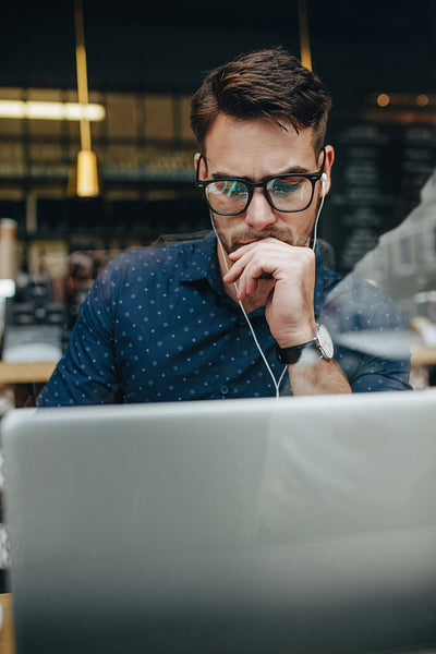 Businessman working on laptop sitting in a cafe