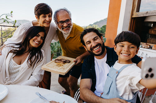 Family enjoying churrasco together during an outdoor lunch gathering