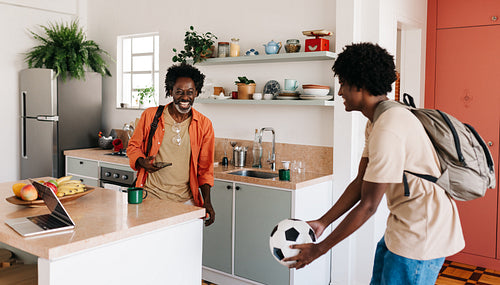 Father and son's joyful morning ritual at home