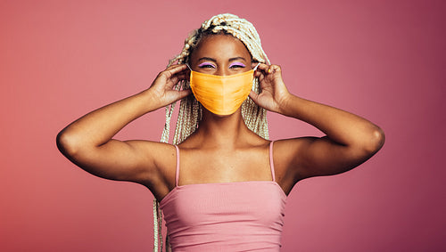 Smiling african woman wearing protective face mask