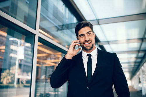 Businessman talking on his mobile phone at airport