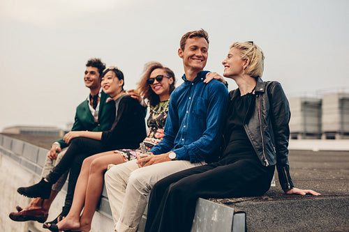Men and women sitting together on rooftop