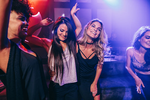 Happy young people having fun at disco