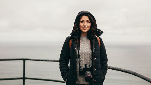 Female tourist by a hillside railing