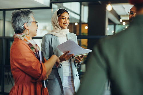 Cheerful businesspeople holding a staff meeting in an office