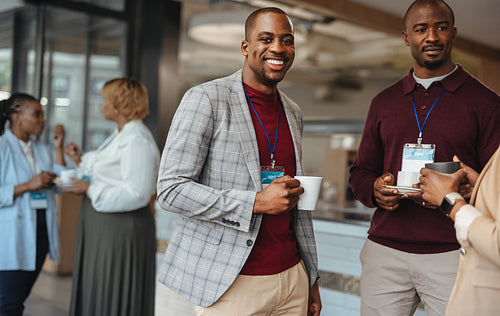 Happy businessmen engaging in casual conversation at a networking event