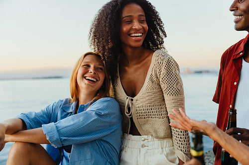 Joyful young adults enjoying summer by the waterfront