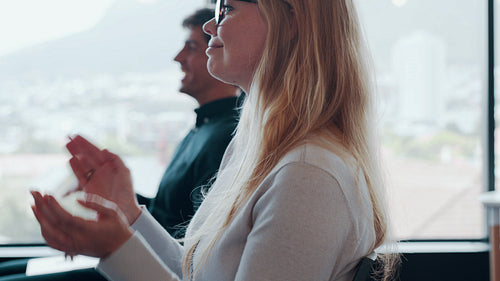 Businesspeople applauding at a conference.