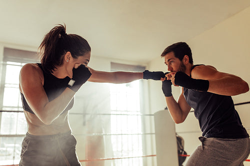 Young boxers fighting inside a boxing ring