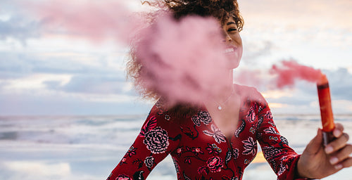 African woman with smoke grenade
