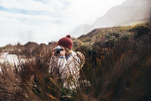 Young woman taking picture of nature