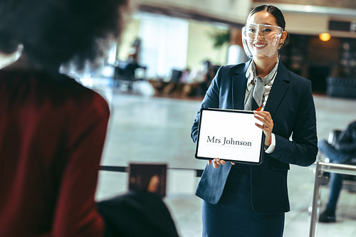 Chauffeur with a sign at airport arrival