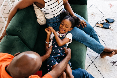 Family enjoying quality time together on living room sofa