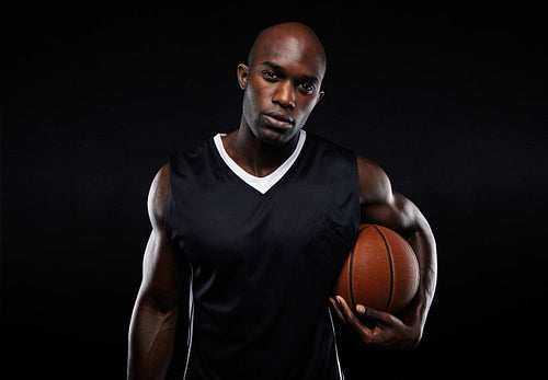 Muscular young basketball player