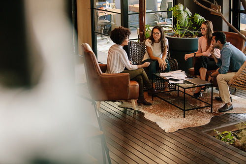 Creative people doing a brainstorming meeting in a modern office