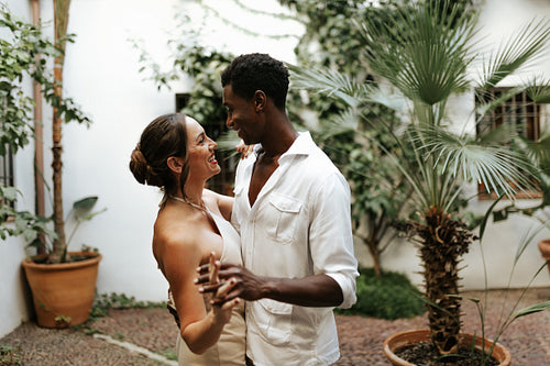 Happy young couple dancing in their backyard