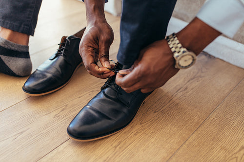 Man tying shoelaces