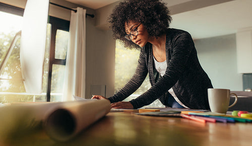Young female architect working on a project from home office
