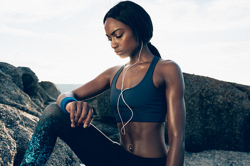 Fit woman relaxing after workout outdoors