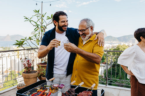 Family enjoying a Brazilian churrasco outdoors with scenic surroundings