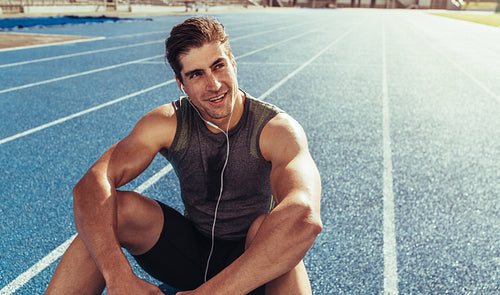 Sprinter relaxing on running track