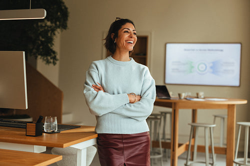 Businesswoman stands by a presentation screen in the office for business branding