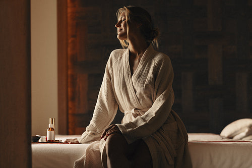Woman enjoying a peaceful spa treatment and aromatherapy session in a relaxing environment