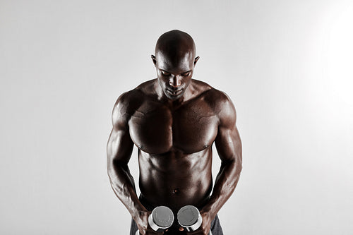 African man holding dumbbells