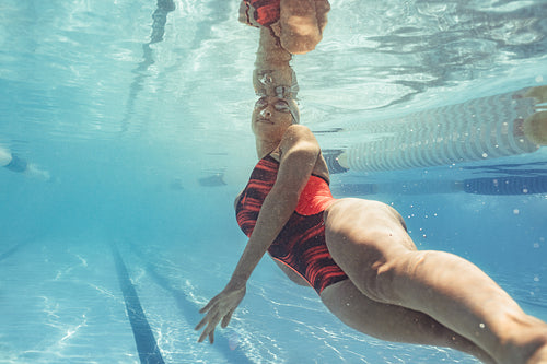 Female swimmer in action inside pool
