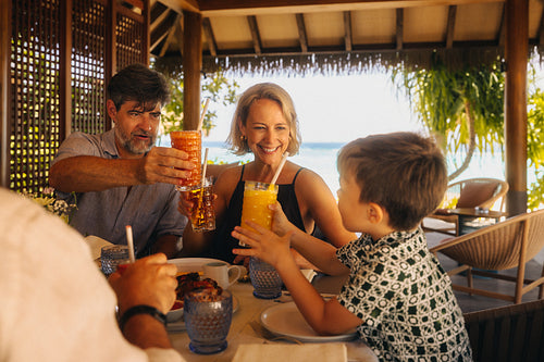 Grandparents enjoying a luxurious high-end resort dining experience with family