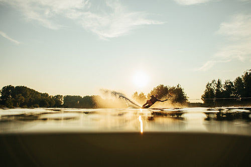 Man water skiing at sunset 