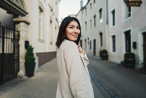 Happy woman exploring a new city while on holiday in Europe