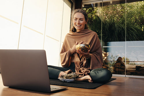 Happy ayurvedic healer streaming a holistic online class at home