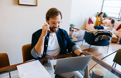 Working dad on call at home with laptop