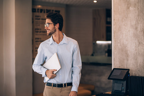 Restaurant manager with a laptop.