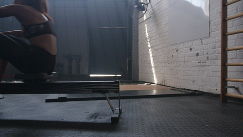 Woman exercising on rowing machine 