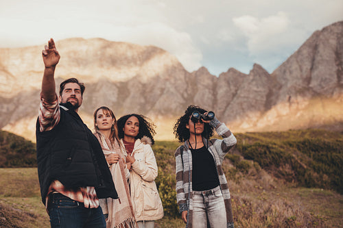 Friends on road trip admiring a landscape