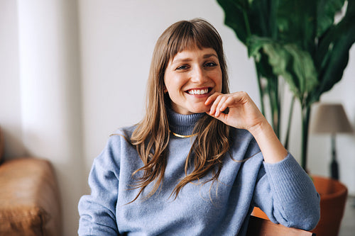 Happy businesswoman smiling at the camera in an office lobby